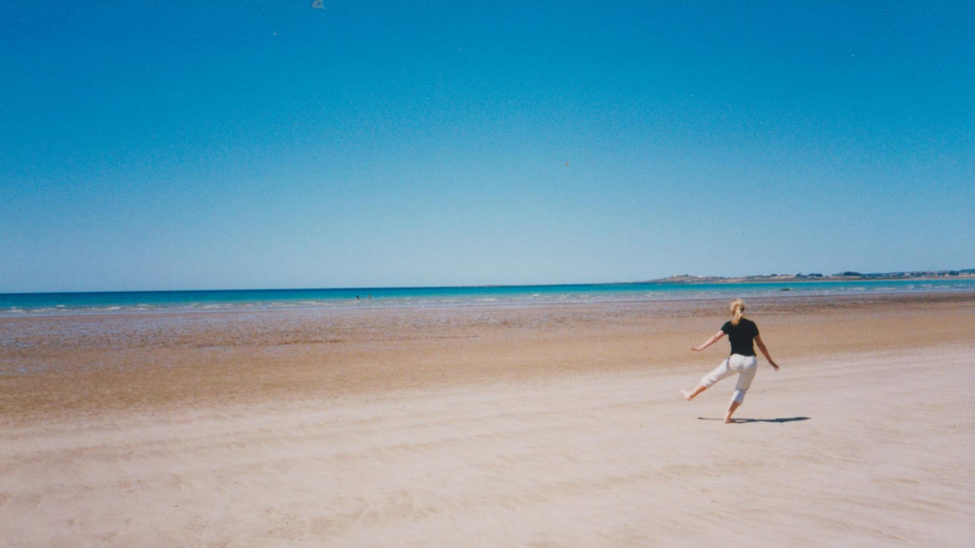 A woman walking gently along a coastal path in early morning light